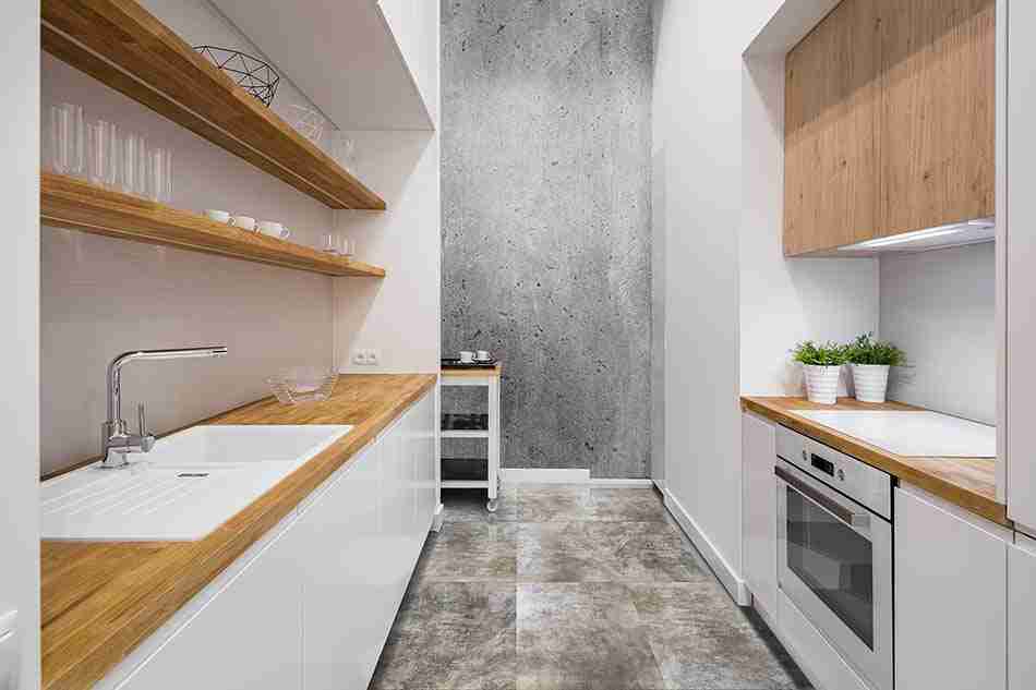 Small, functional kitchen with wooden countertop and hexagonal floor tiles