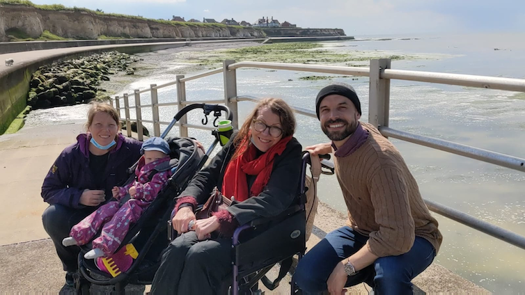 A family poses for a photo at the beach