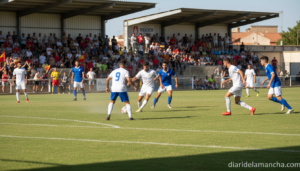 Football players in a regional Spanish football match in a small stadium in Castilla-La Mancha, sunny day, match in progre...