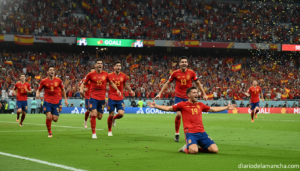 Spain national football team players in red jerseys celebrating a goal on a stadium pitch, action photography style, stadi...