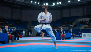A young martial arts athlete in a white karate gi performing a kata technique on a competition tatami, focused expression,...