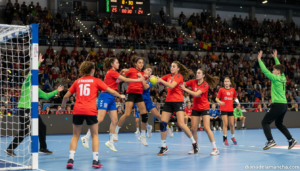 Youth handball match scene, teenage players in action during a handball championship game in an indoor sports arena, dynam...