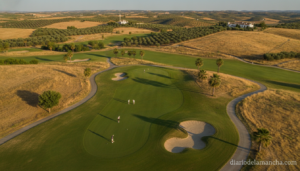 Golf course in Castilla-La Mancha region, Spain, players on a green playing pitch and putt, sunny summer day, aerial view ...