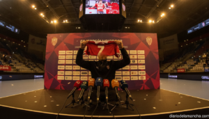 Handball player being presented at a press conference, holding up a team jersey, indoor sports venue, no identifiable face...