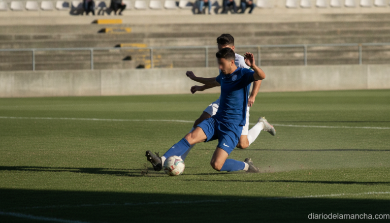 Wide shot of an amateur regional football match, a player in a generic plain dark kit (no visible logos or sponsor names) ...