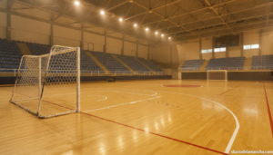 Journalistic photo of an indoor futsal court in Spain, empty stands, polished wooden court with painted lines, futsal goal...