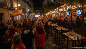 Photojournalistic realistic photo of a lively street celebration at night in a Spanish town, people waving Spanish nationa...