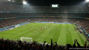 Stadium packed with fans during an intense international football match under floodlights, aerial perspective showing the ...