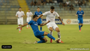 Action shot of a lower-division Spanish football match during preseason, players in generic unbranded kits challenging for...